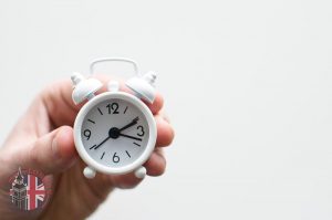 Hand holding a tiny clock