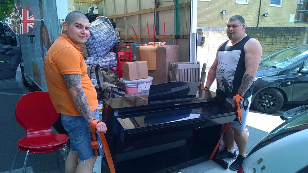 Movers lifting a piano